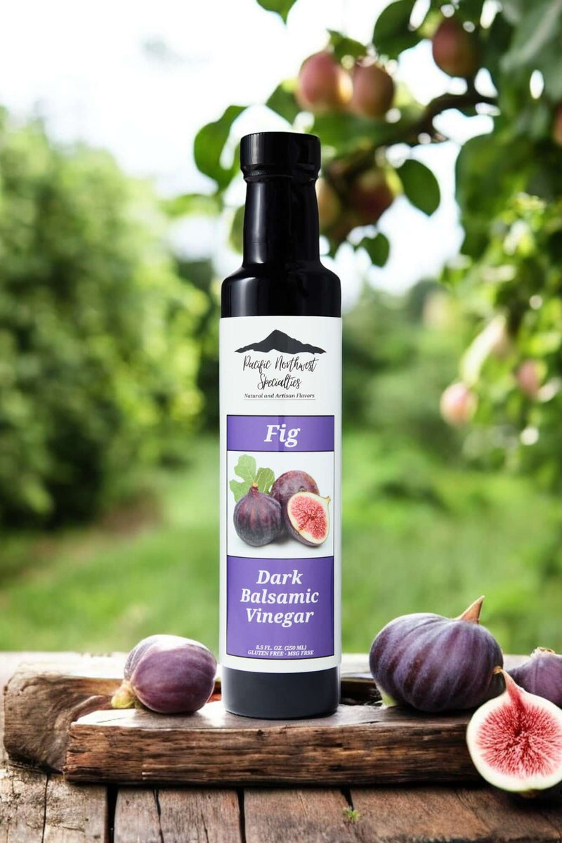 Fig Dark Balsamic Vinegar bottle surrounded by fresh figs in a natural setting.