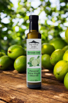 Persian Lime Extra Virgin Olive Oil bottle with fresh limes in the background showcasing vibrant flavor.